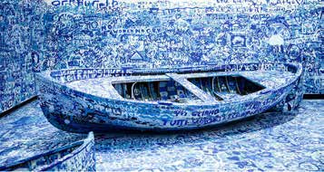 Blue painted boat installation covered in handwritten messages